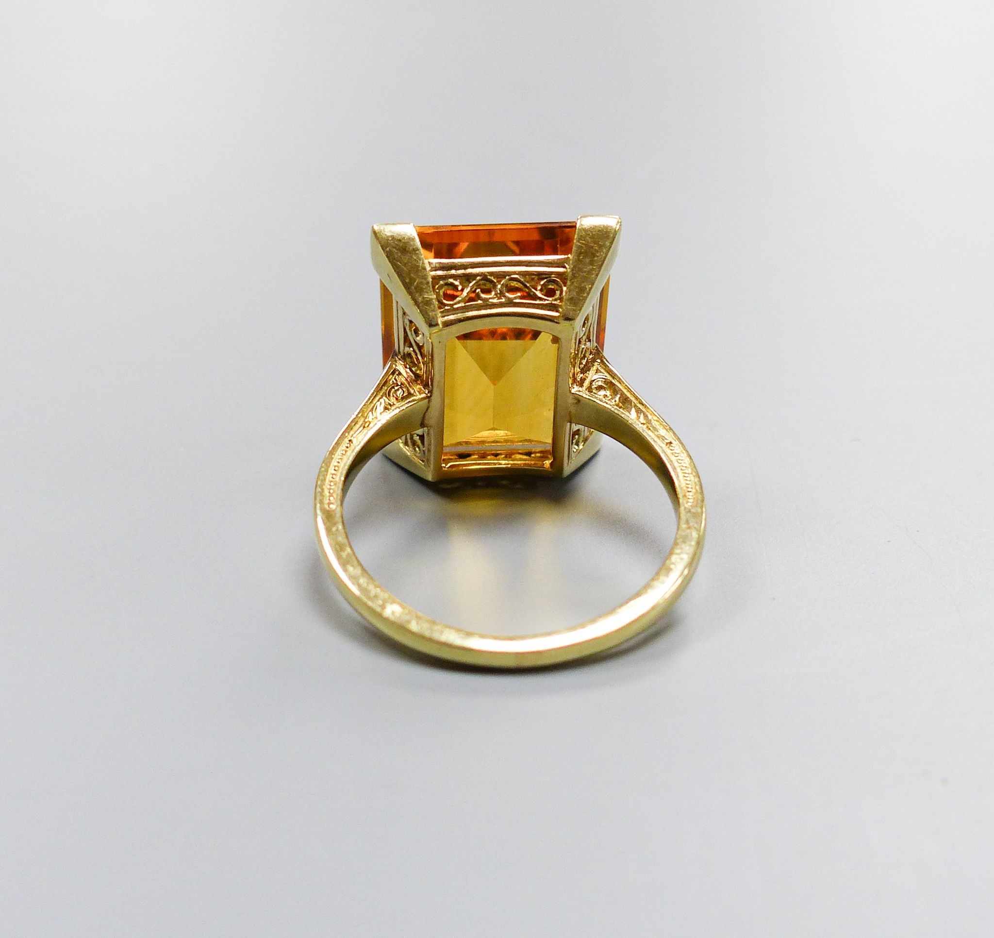 A modern yellow metal and emerald cut citrine set dress ring, size K, gross weight 6.6 grams.